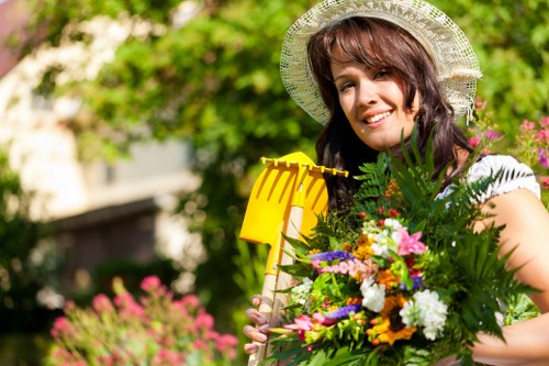 Professional gardener trimming hedges